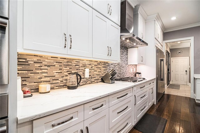 850 Cog Hl, Mcdonough, GA 30253 - kitchen with dark wood-style flooring, crown molding, white cabinetry, stainless steel appliances, and wall chimney exhaust hood