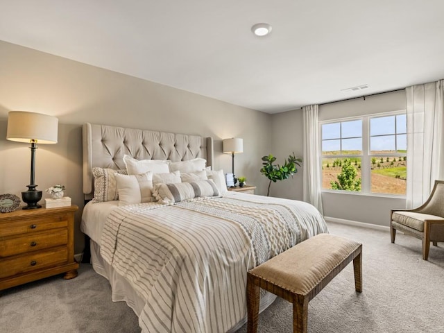 bedroom with light carpet, visible vents, and baseboards