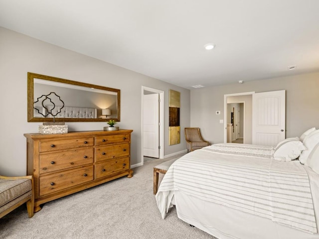 bedroom featuring light carpet and baseboards