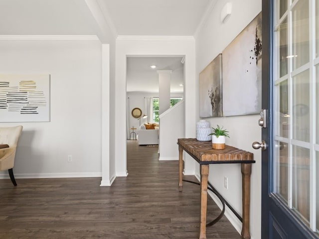 corridor featuring ornamental molding, baseboards, and dark wood-style floors