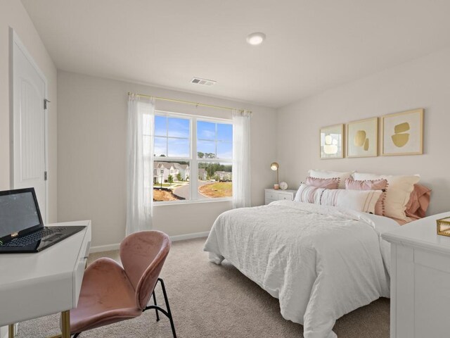 carpeted bedroom with visible vents and baseboards