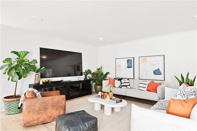 living room with ornamental molding and wood finished floors