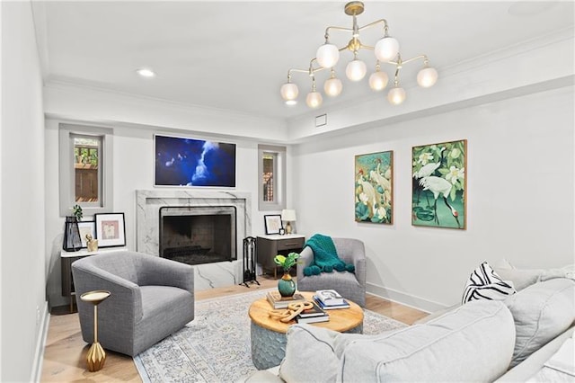 living room with crown molding, baseboards, wood finished floors, and a premium fireplace