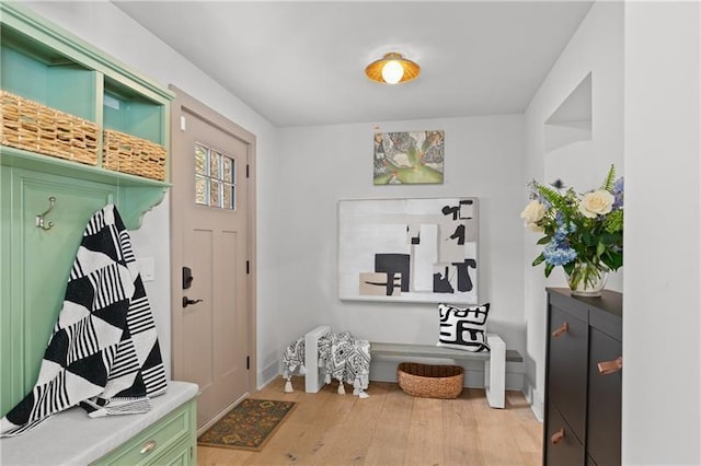 mudroom featuring light wood-style floors and baseboards