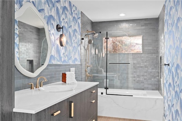 full bathroom featuring vanity, shower / bath combination, and tile walls