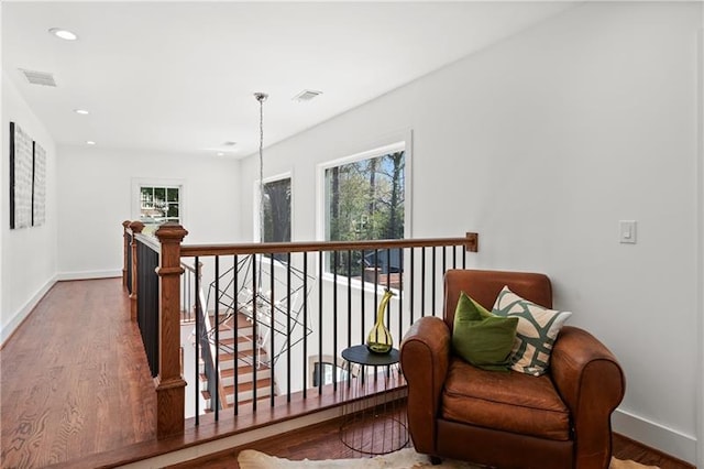 hallway featuring recessed lighting, baseboards, an upstairs landing, wood finished floors, and visible vents