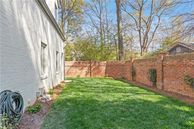 view of yard with a fenced backyard