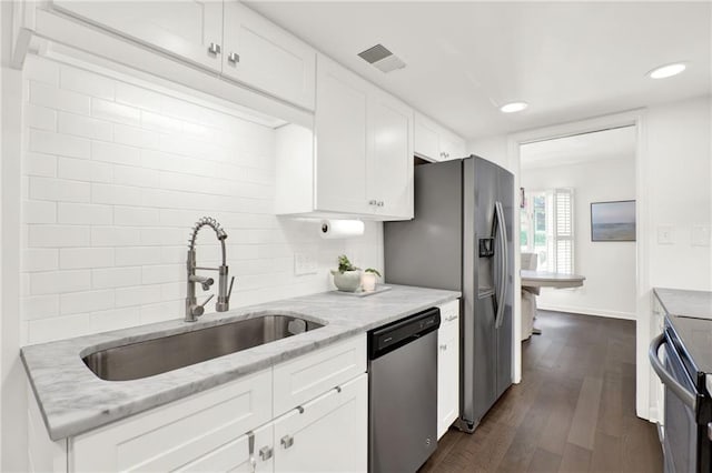12 Ivy Rdg NE, Atlanta, GA 30342 - kitchen featuring stainless steel appliances, white cabinetry, light stone countertops, dark wood-type flooring, and tasteful backsplash