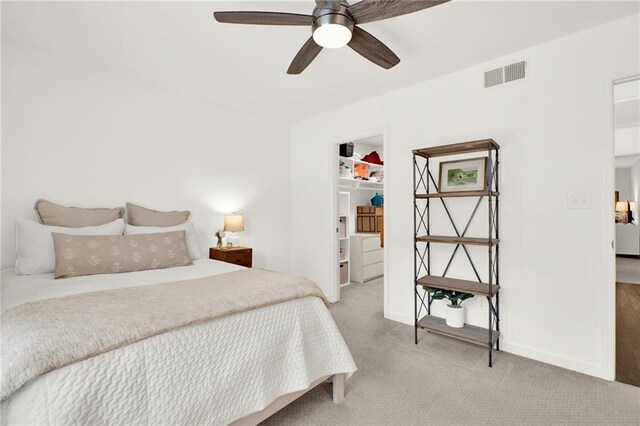 12 Ivy Rdg NE, Atlanta, GA 30342 - bedroom with light carpet, a spacious closet, and a ceiling fan