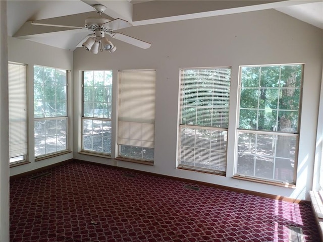 unfurnished sunroom with ceiling fan and vaulted ceiling