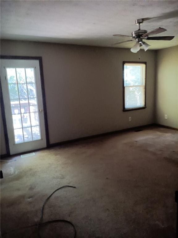 empty room featuring carpet flooring and ceiling fan