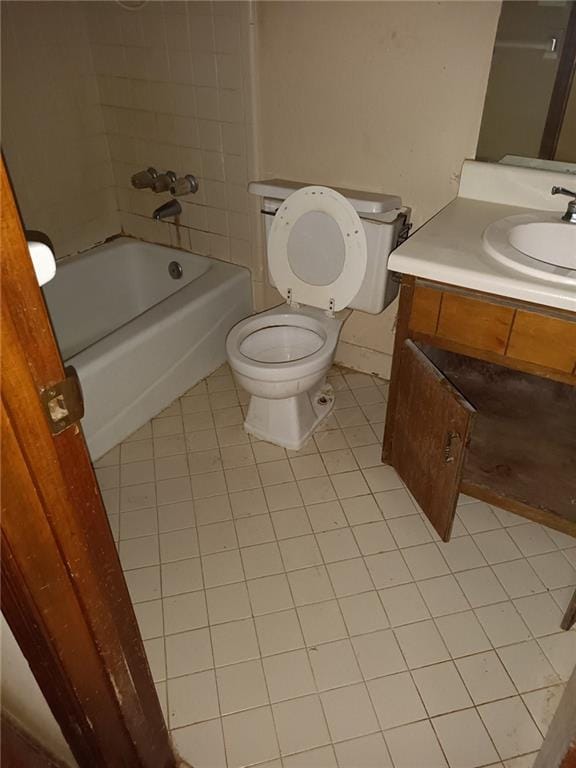 full bathroom featuring tile patterned floors, vanity, toilet, and tiled shower / bath combo