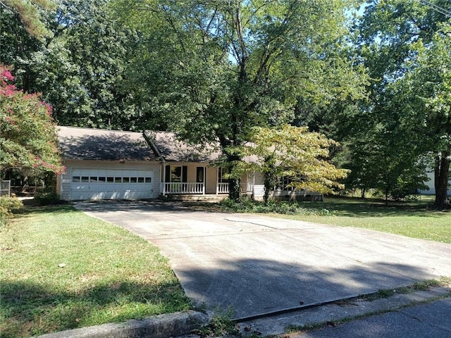 view of front of home featuring a porch, a garage, and a front yard