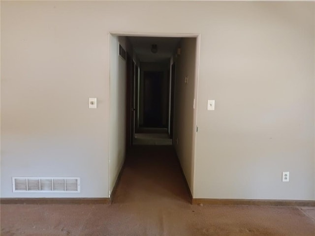 hall featuring carpet flooring