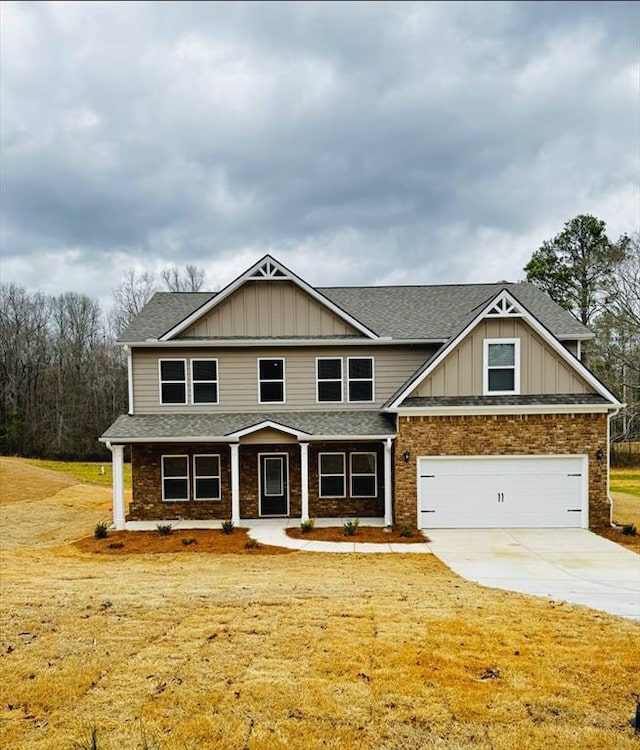 craftsman house with a garage, board and batten siding, roof with shingles, and driveway