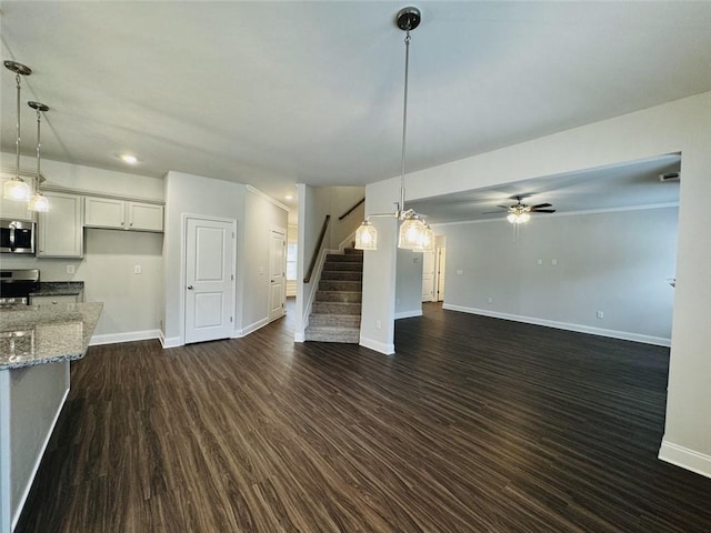 unfurnished living room featuring ceiling fan, recessed lighting, baseboards, dark wood-style floors, and stairway