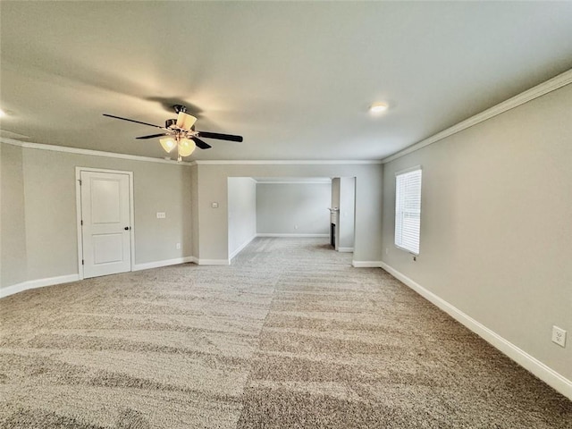 empty room featuring baseboards, ornamental molding, ceiling fan, and light carpet
