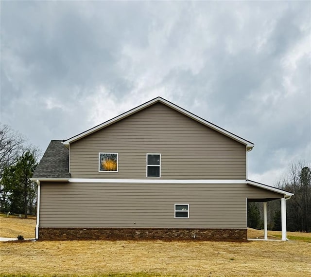 view of side of home featuring a lawn