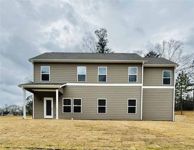 rear view of property with a shingled roof