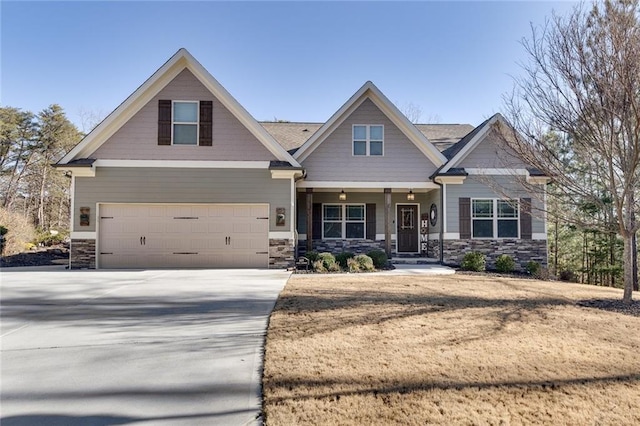 craftsman inspired home featuring covered porch and a garage