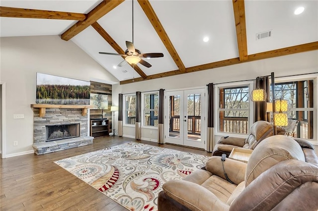 living room featuring ceiling fan, french doors, high vaulted ceiling, wood-type flooring, and a fireplace