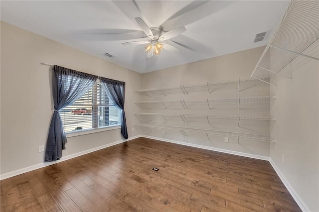 empty room featuring hardwood / wood-style flooring and ceiling fan