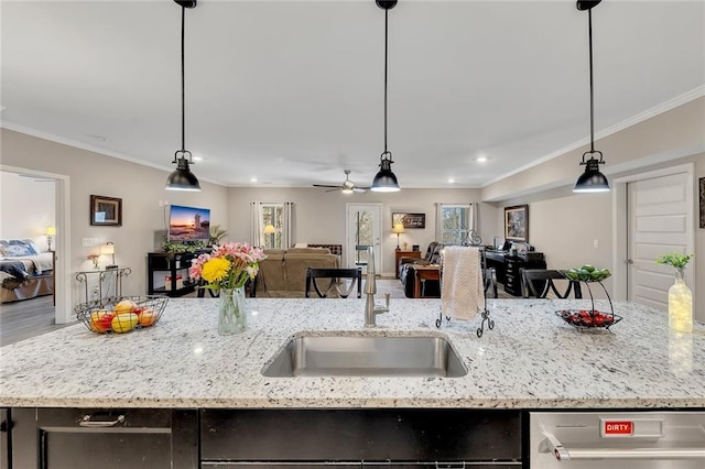 kitchen featuring pendant lighting, ceiling fan, and light stone countertops