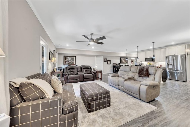 living room featuring hardwood / wood-style flooring and ceiling fan