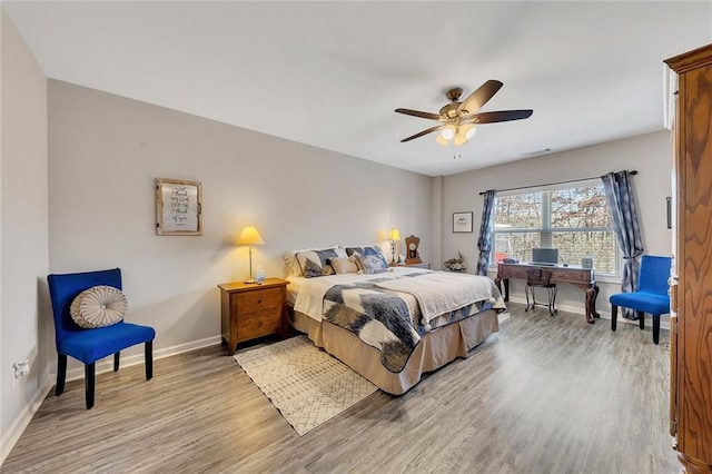 bedroom with light hardwood / wood-style flooring and ceiling fan