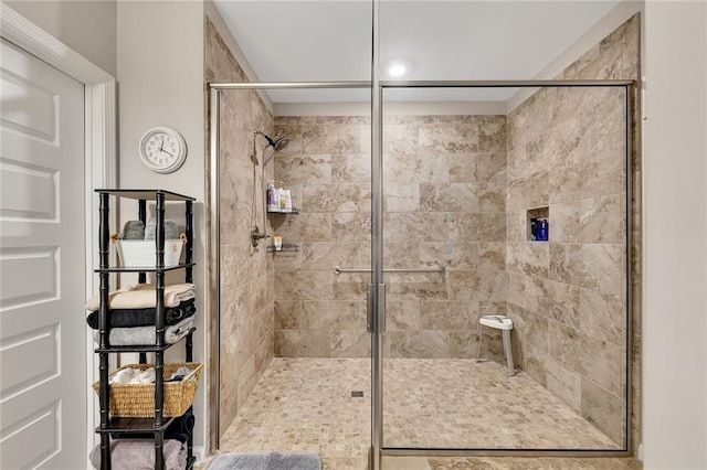 bathroom featuring a shower with shower door