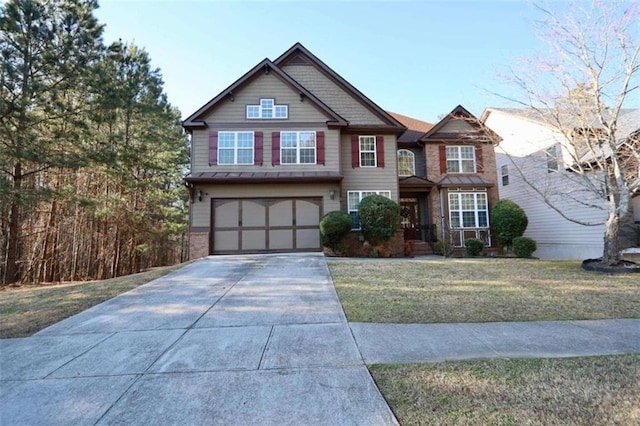 craftsman-style home featuring concrete driveway, a front lawn, and an attached garage