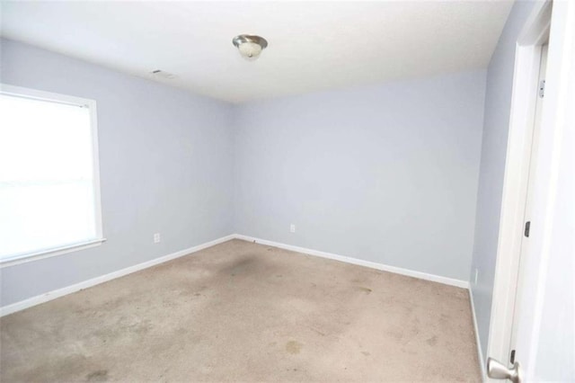 carpeted spare room with baseboards