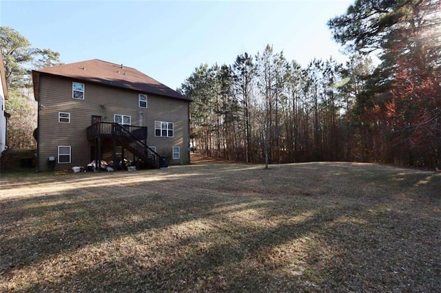 view of yard featuring stairs and a deck