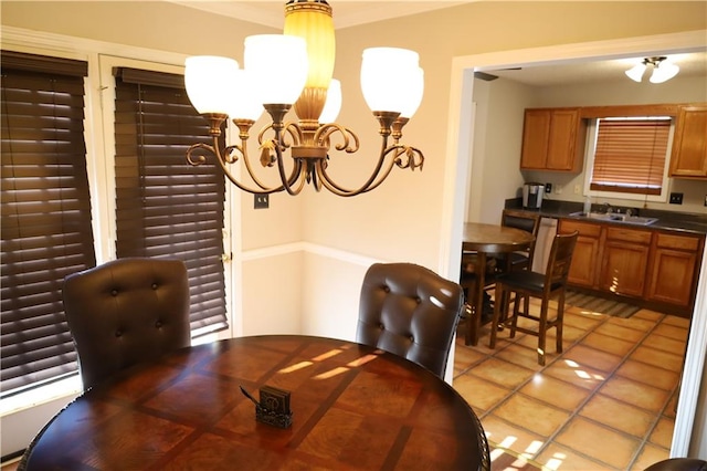 tiled dining space featuring sink and an inviting chandelier