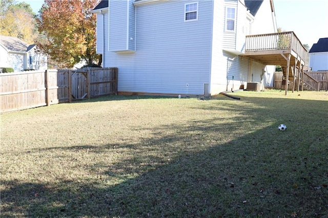 view of yard with a deck and central air condition unit