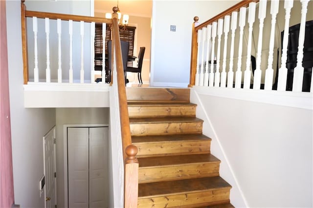 stairs featuring an inviting chandelier