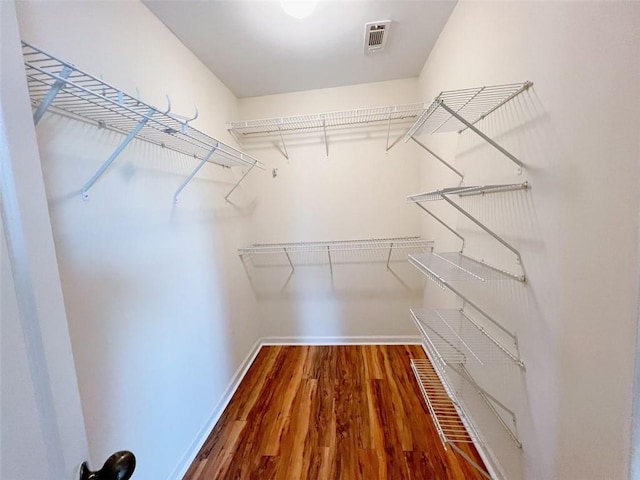 spacious closet featuring hardwood / wood-style floors