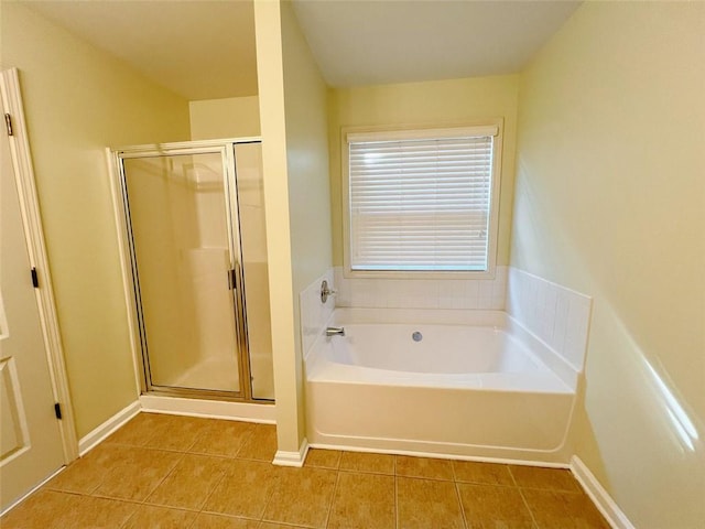 bathroom featuring plus walk in shower and tile patterned flooring