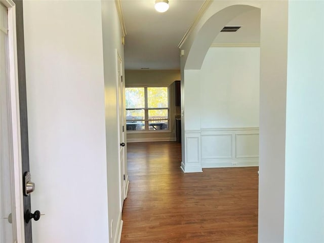 corridor featuring dark hardwood / wood-style floors and crown molding