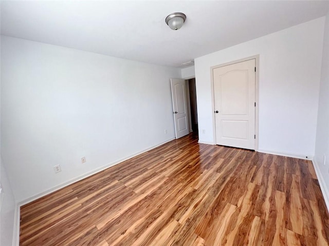 empty room with hardwood / wood-style flooring