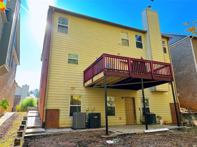 rear view of house with cooling unit, a patio area, and a wooden deck