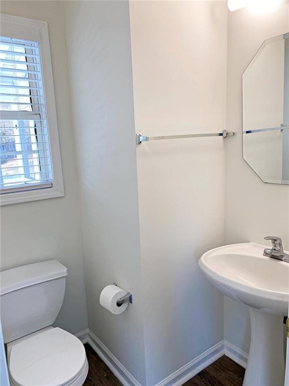 bathroom featuring wood-type flooring and toilet