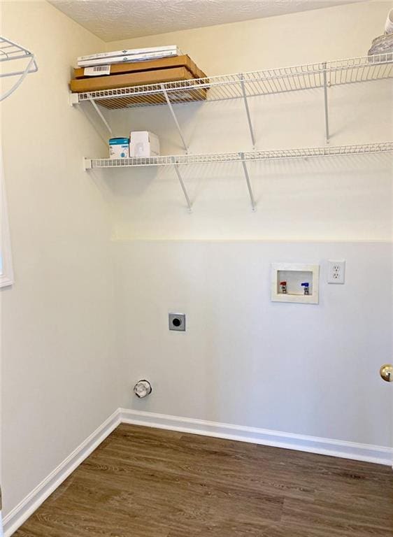 clothes washing area with dark hardwood / wood-style flooring, hookup for a washing machine, and electric dryer hookup