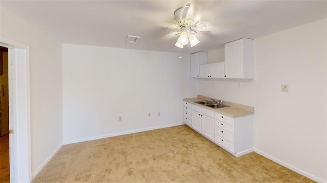 empty room featuring sink and light carpet