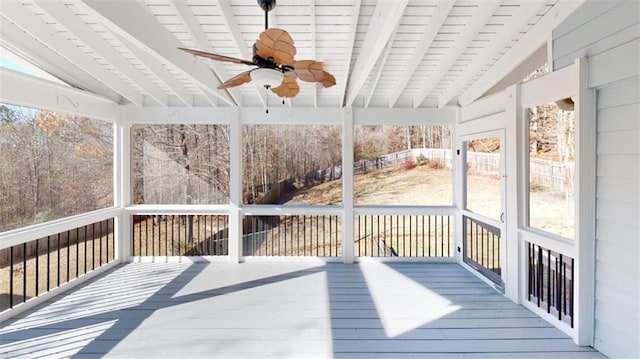 unfurnished sunroom with lofted ceiling with beams, wooden ceiling, and ceiling fan