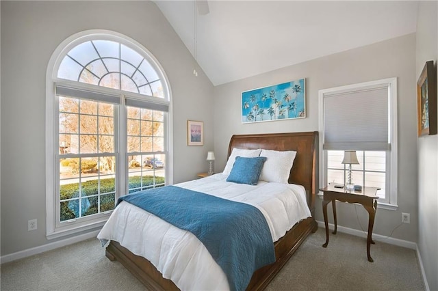 carpeted bedroom with ceiling fan, high vaulted ceiling, and multiple windows