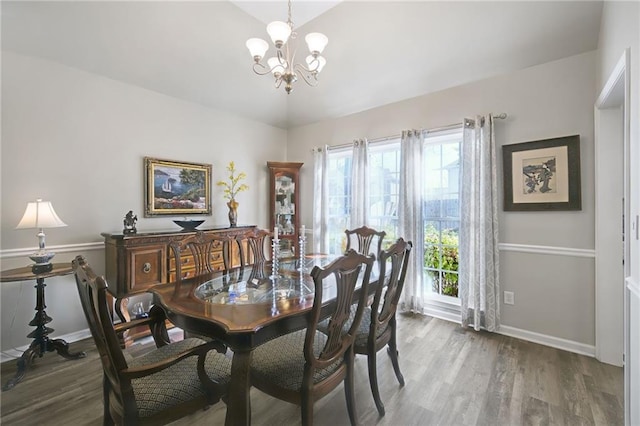 dining space with an inviting chandelier and hardwood / wood-style flooring