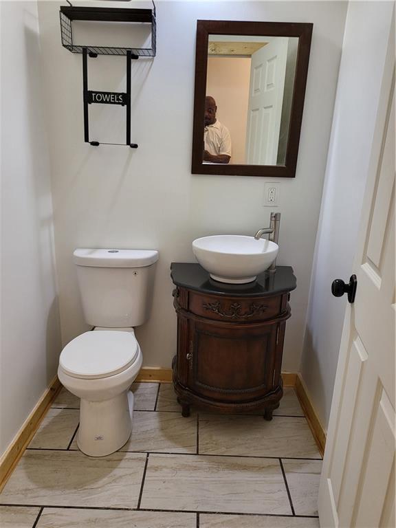 1167 Oakland Dr SW, Atlanta, GA 30310 - bathroom featuring baseboards, vanity, and toilet
