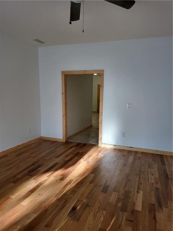 1167 Oakland Dr SW, Atlanta, GA 30310 - unfurnished room with ceiling fan, wood finished floors, and baseboards