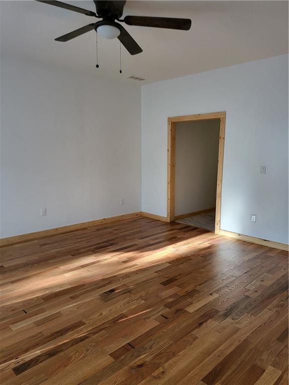 1167 Oakland Dr SW, Atlanta, GA 30310 - empty room featuring wood finished floors, ceiling fan, and baseboards